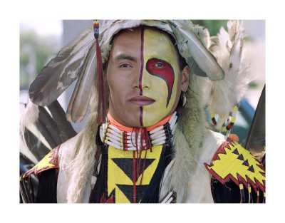 Title: Kevin Haywahe, Assiniboine First Nation, 1990, pigment print on archival paper. By Jeff Thomas: "The photo I have attached is from my powwow portrait series "Strong Hearts." My aim is to take an iconic image of Indianness and invite each dancer to return the tourist gaze and open a conversation."