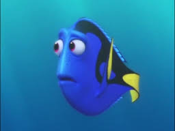 An animated scene from the Pixar film "Finding Dory." Dory, a regal blue tang fish looks pensive and sad.