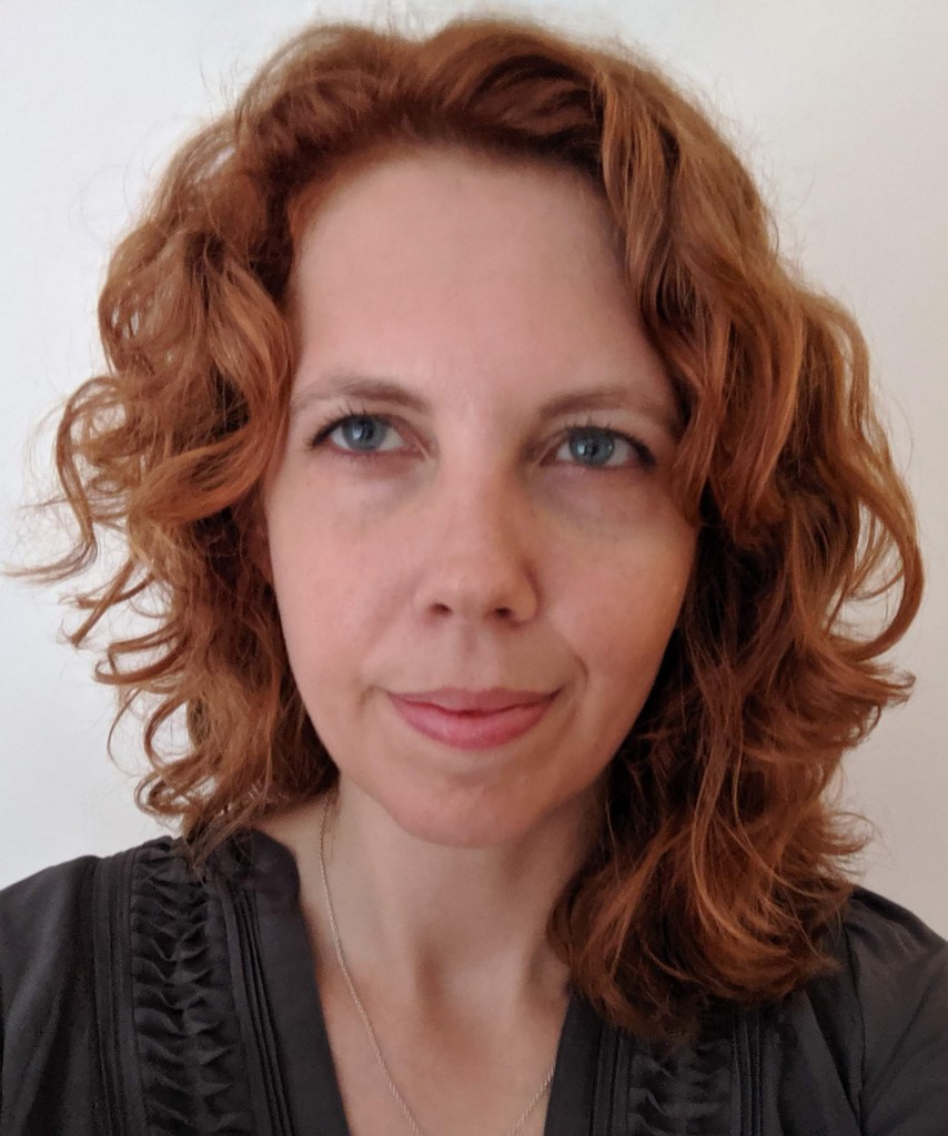 Jessica Murray is a middle-aged white woman, with curly red hair and a determined look on her face.