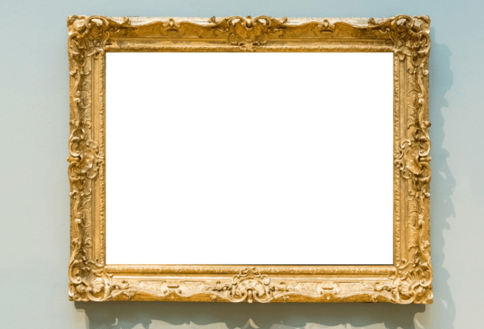 Ornate gold frame with a blank white canvas on a wall