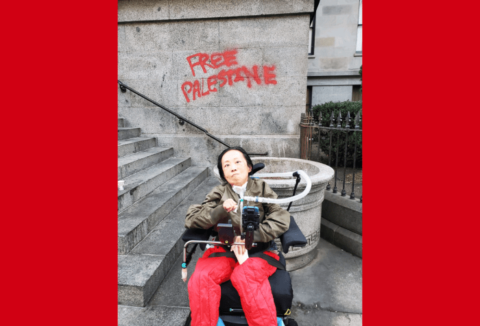 A graphic with a red background and in the center is a photo of an Asian American disabled woman in a wheelchair with a tracheostomy attached to a ventilator. Behind her is a building FREE PALESTINE written in red paint